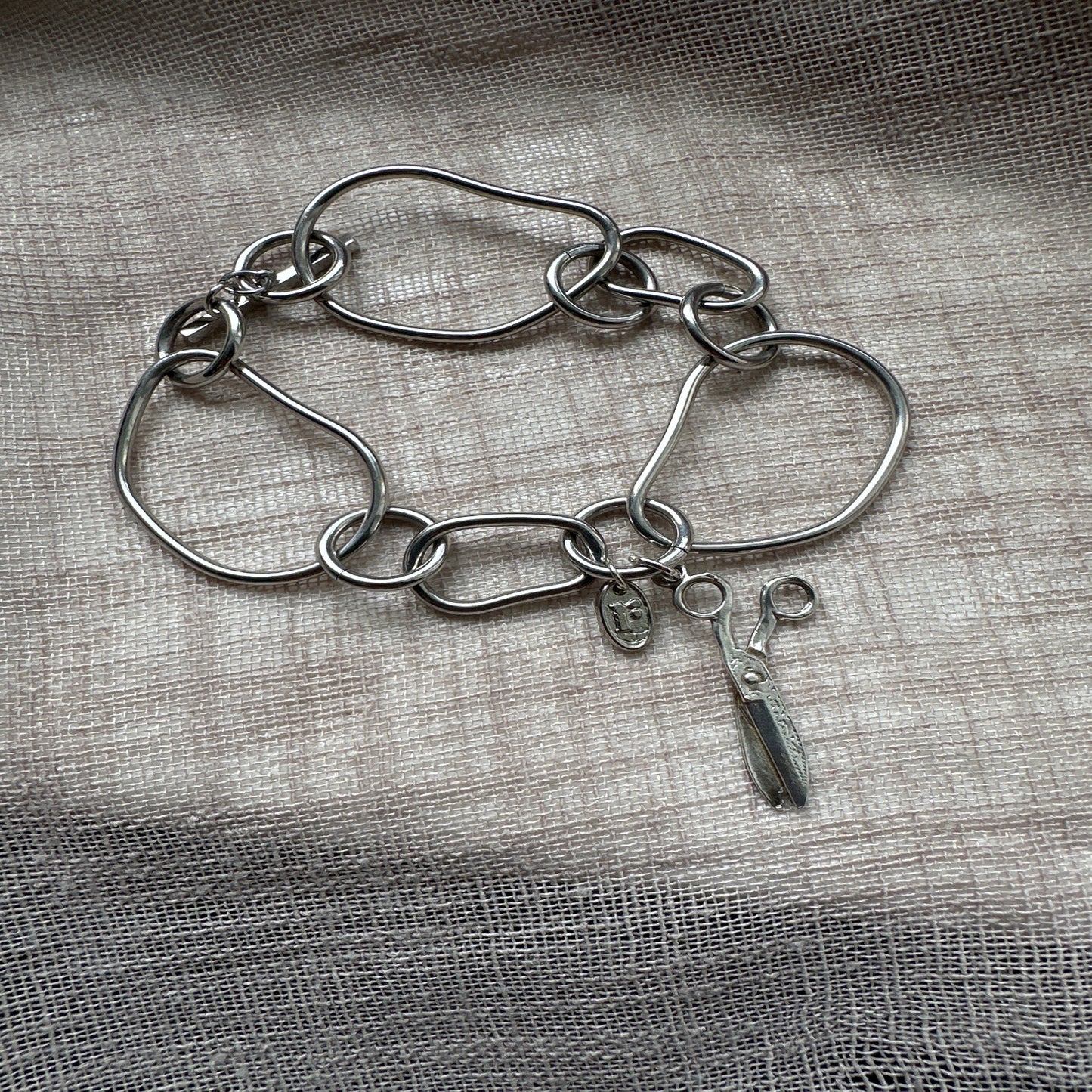 Statement charm bracelet by Regilt – bold cut-style vintage piece.