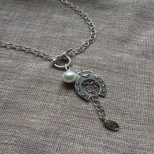 Lucky charm necklace from Regilt â€“ bold, quirky statement piece.