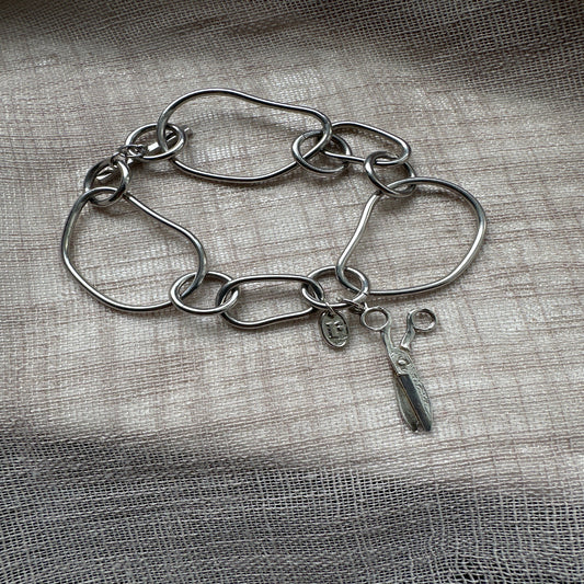 Statement charm bracelet by Regilt â€“ bold cut-style vintage piece.